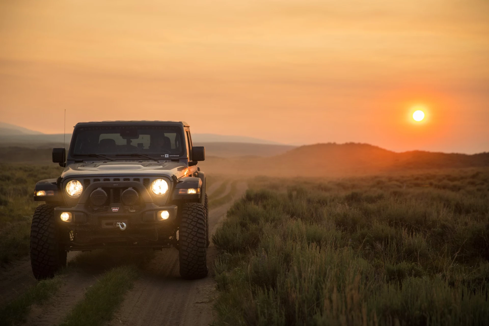 Modified Jeep Gladiator on a desert trail at sunrise